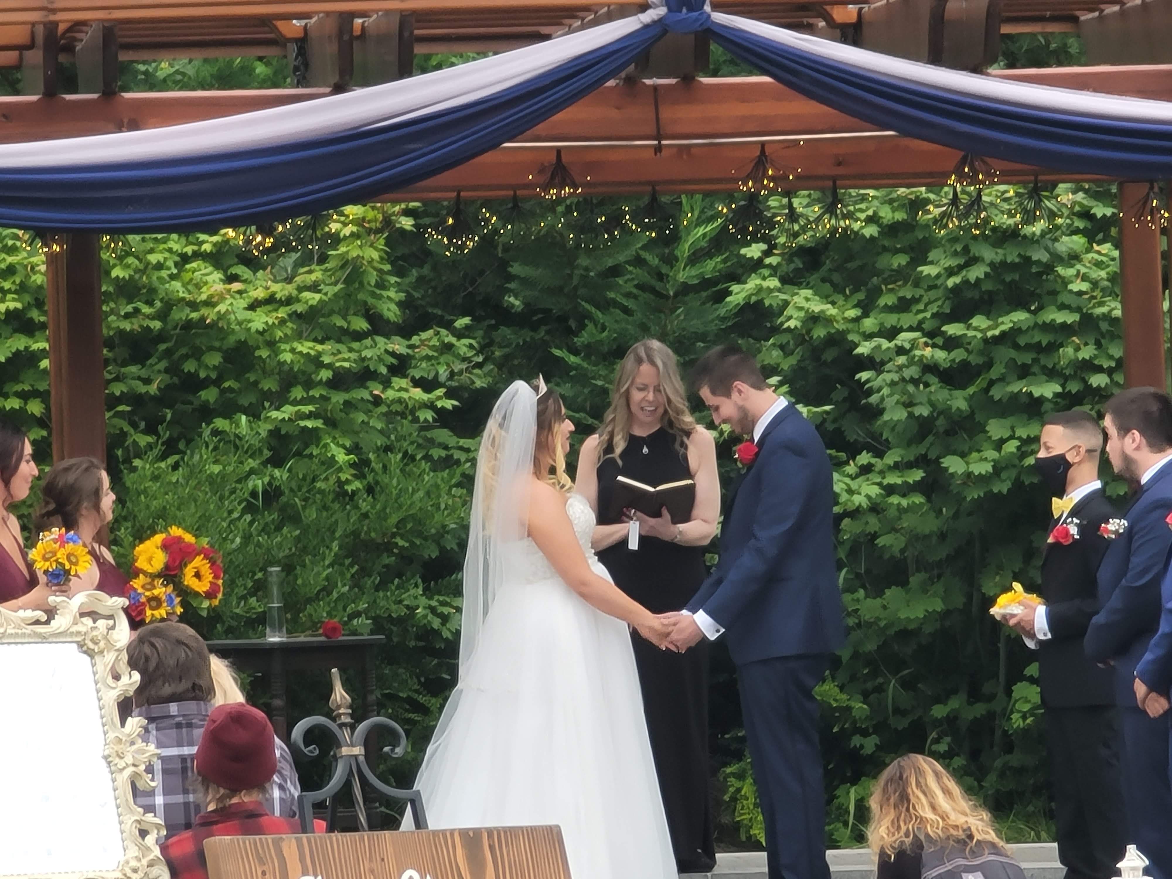 Wedding ceremony with blue and white tulle arch