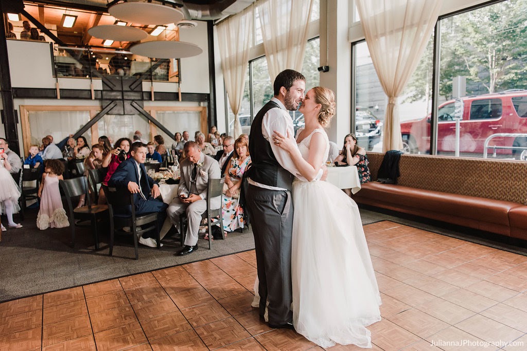 Wedding couple dancing, groom in grey suit